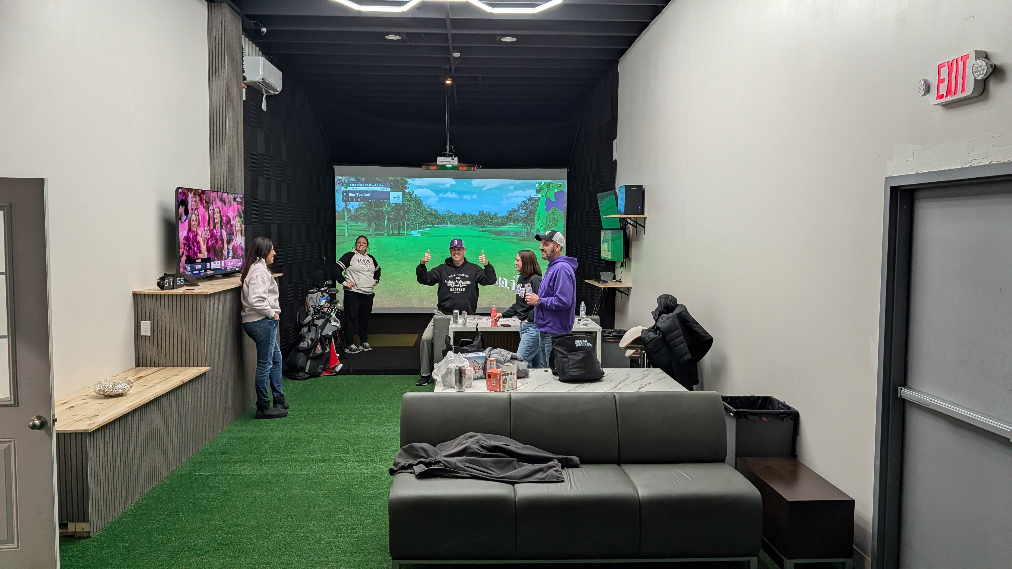 Golfers Playing Indoor Simulator